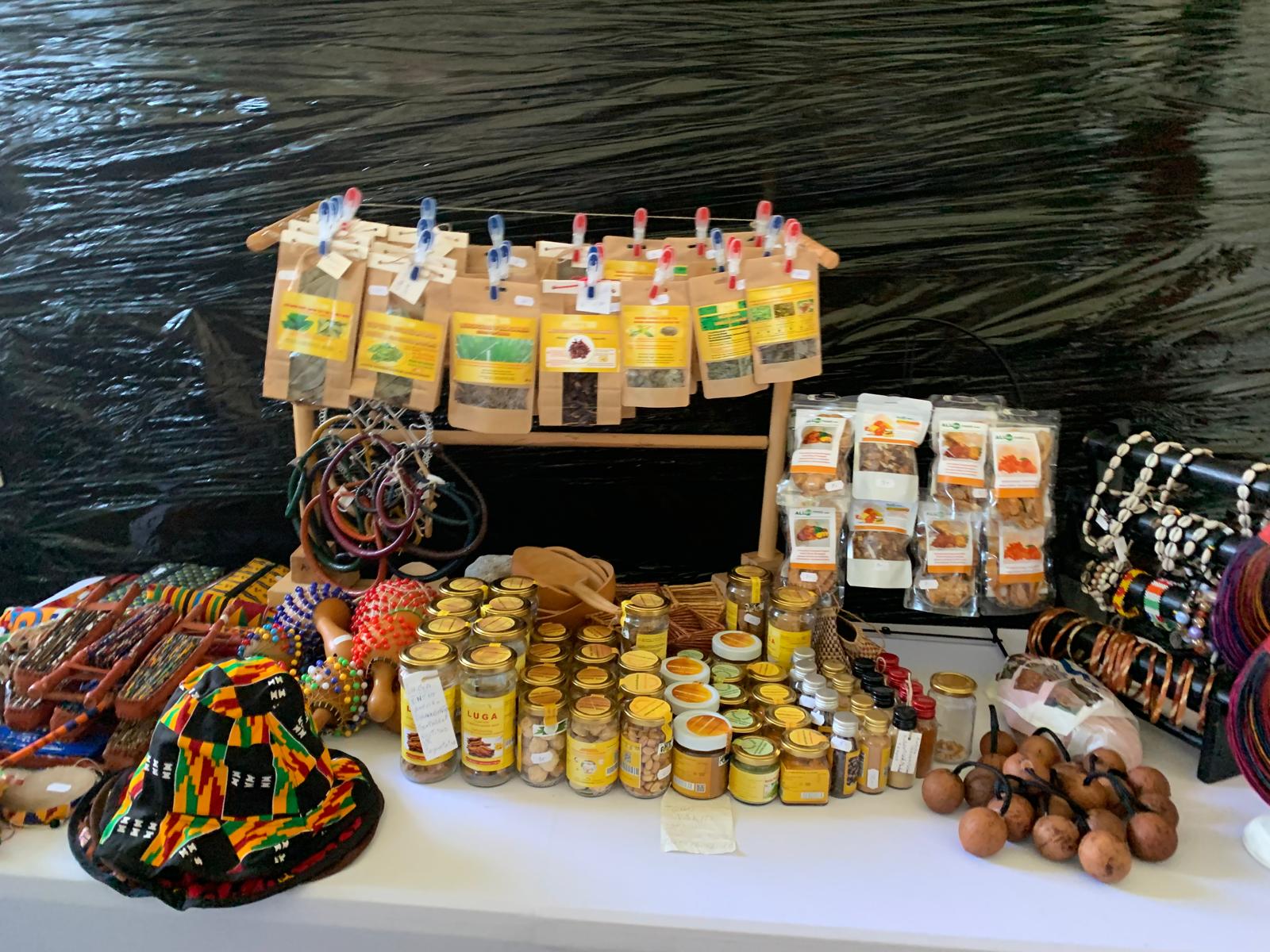 TogoSunny stall table with jewellery, hats and snacks