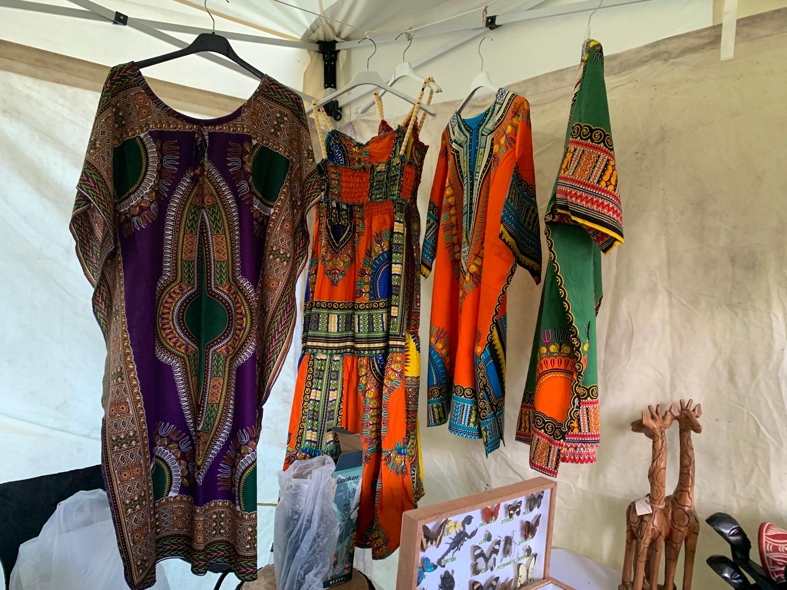 Dashiki dresses and wooden giraffe carvings on display