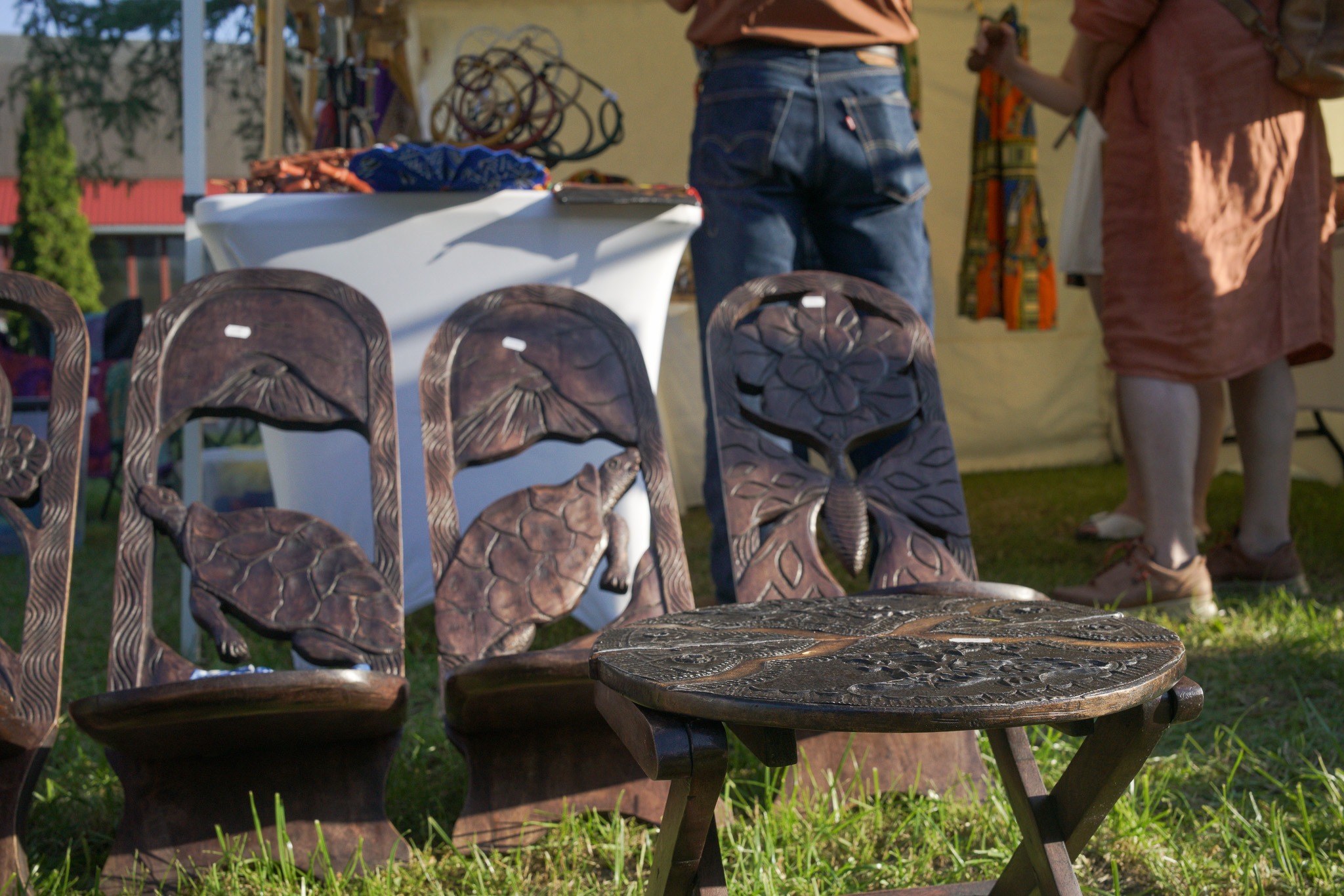 Close-up of carved black wood masks and pendants