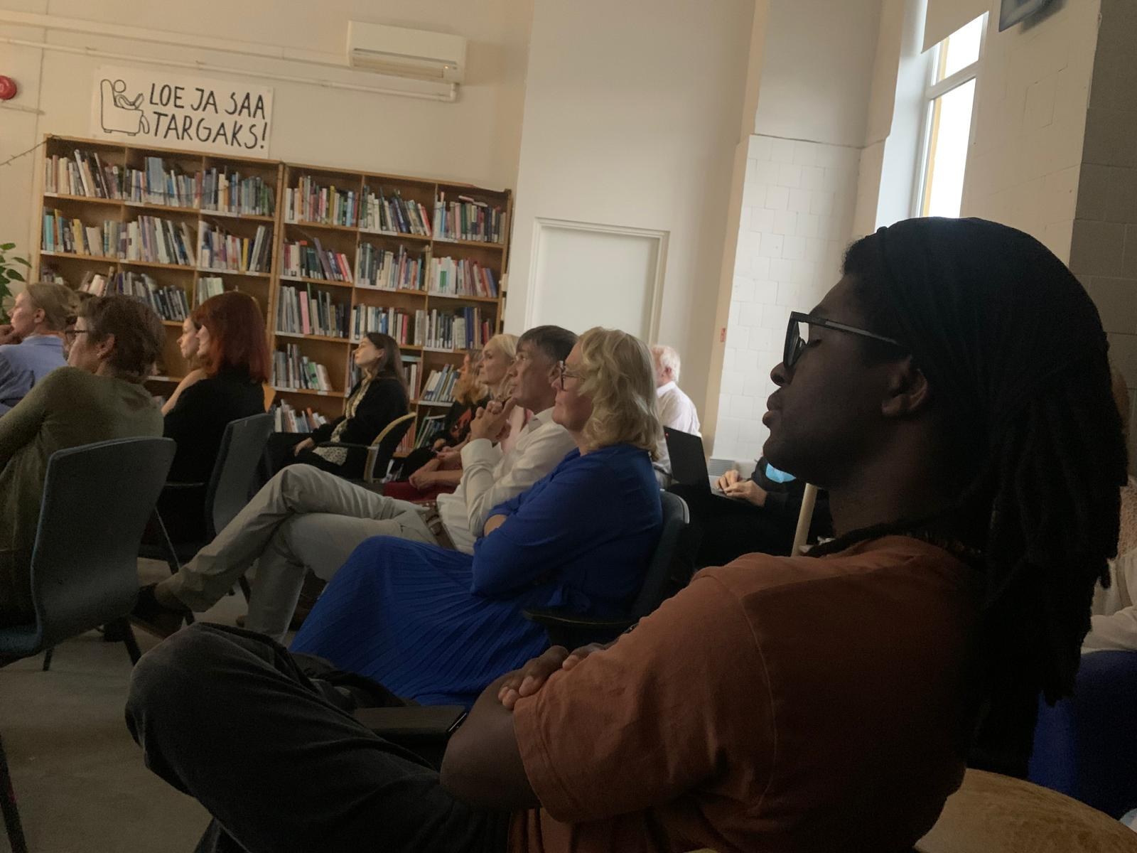 Senam Tsogbe sitting among the audience, listening