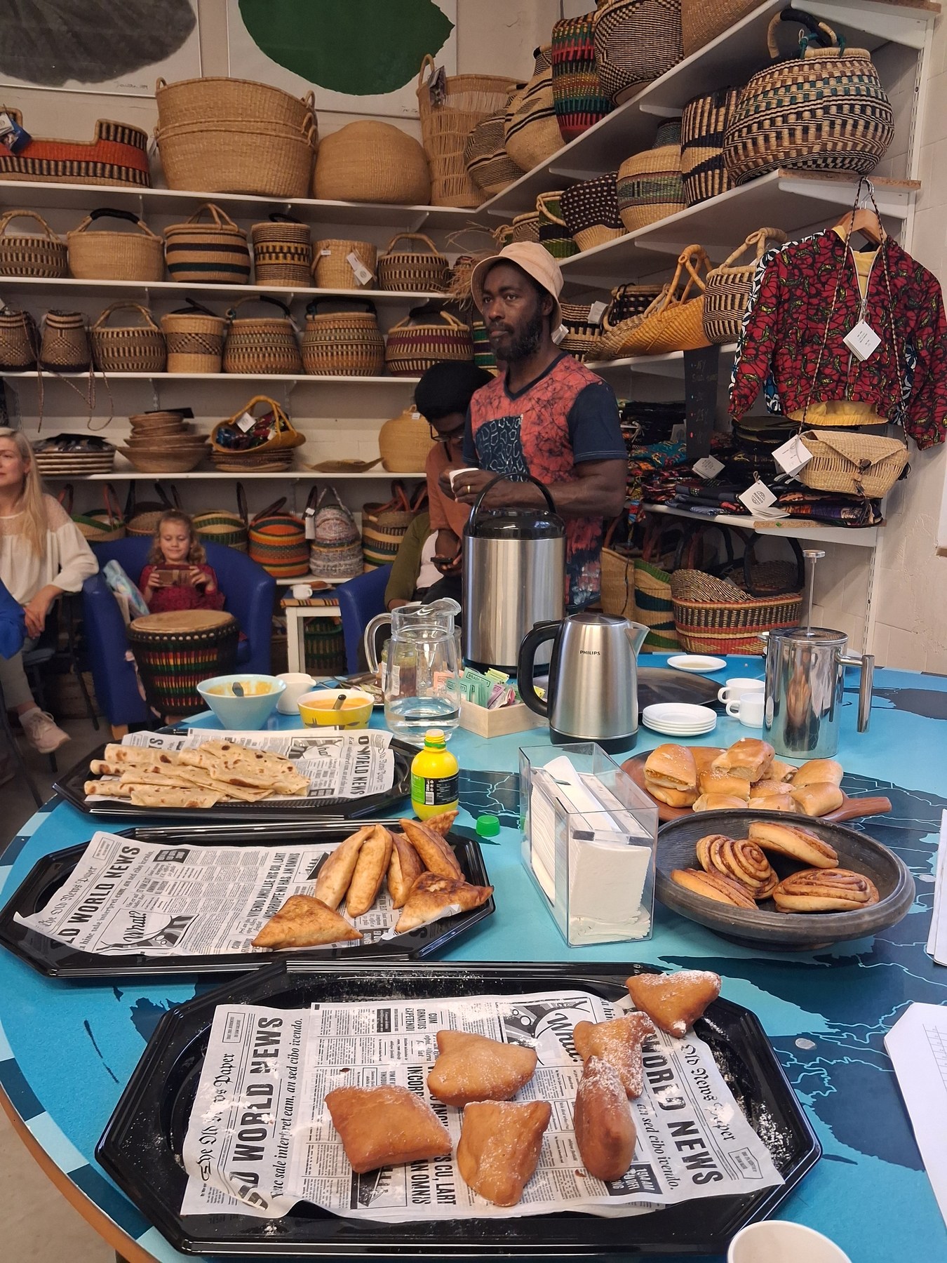Table with bissap, samosas, chapati and pastries