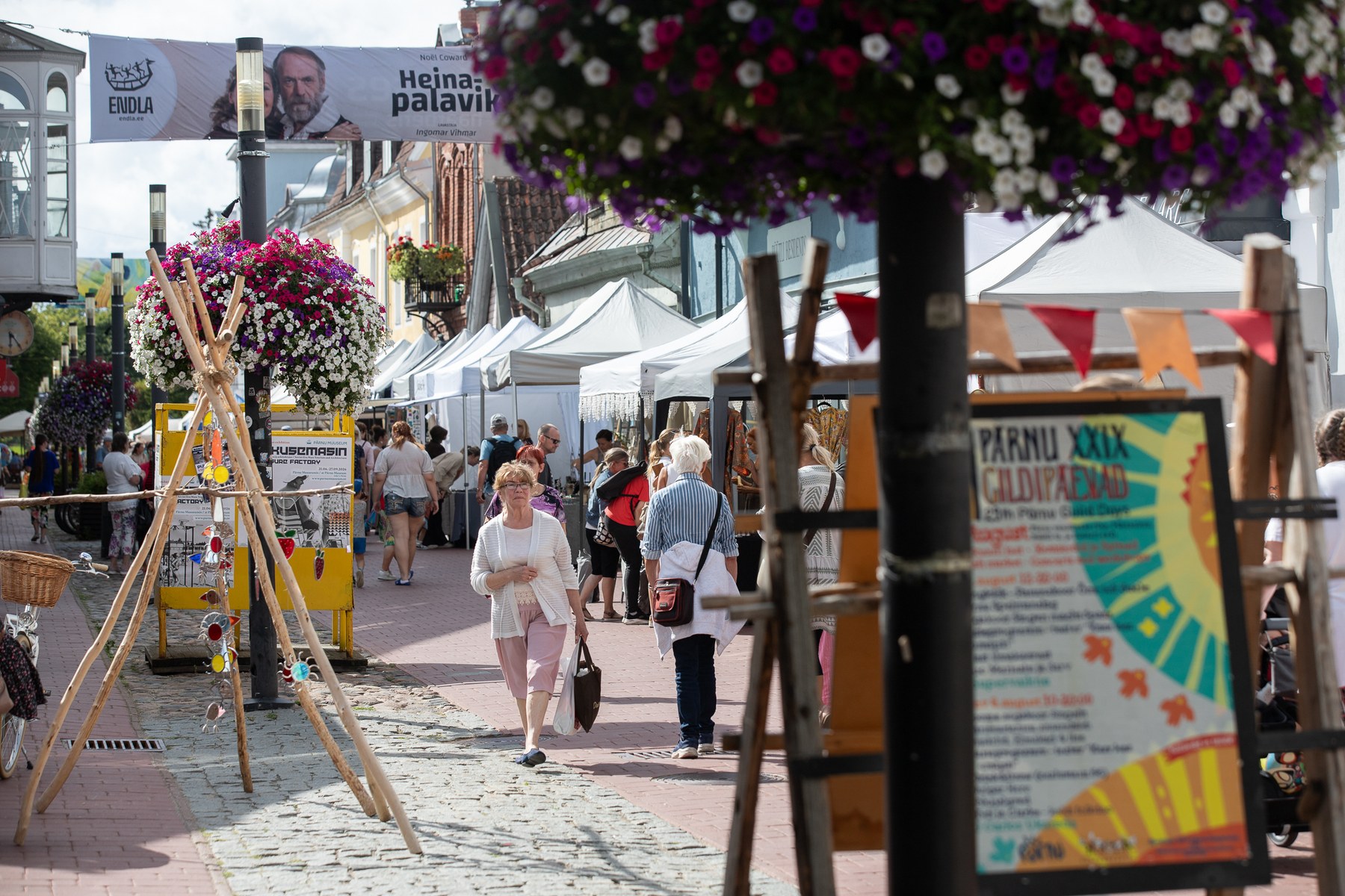 Pärnu old town street during Guild Days, festival sign visible