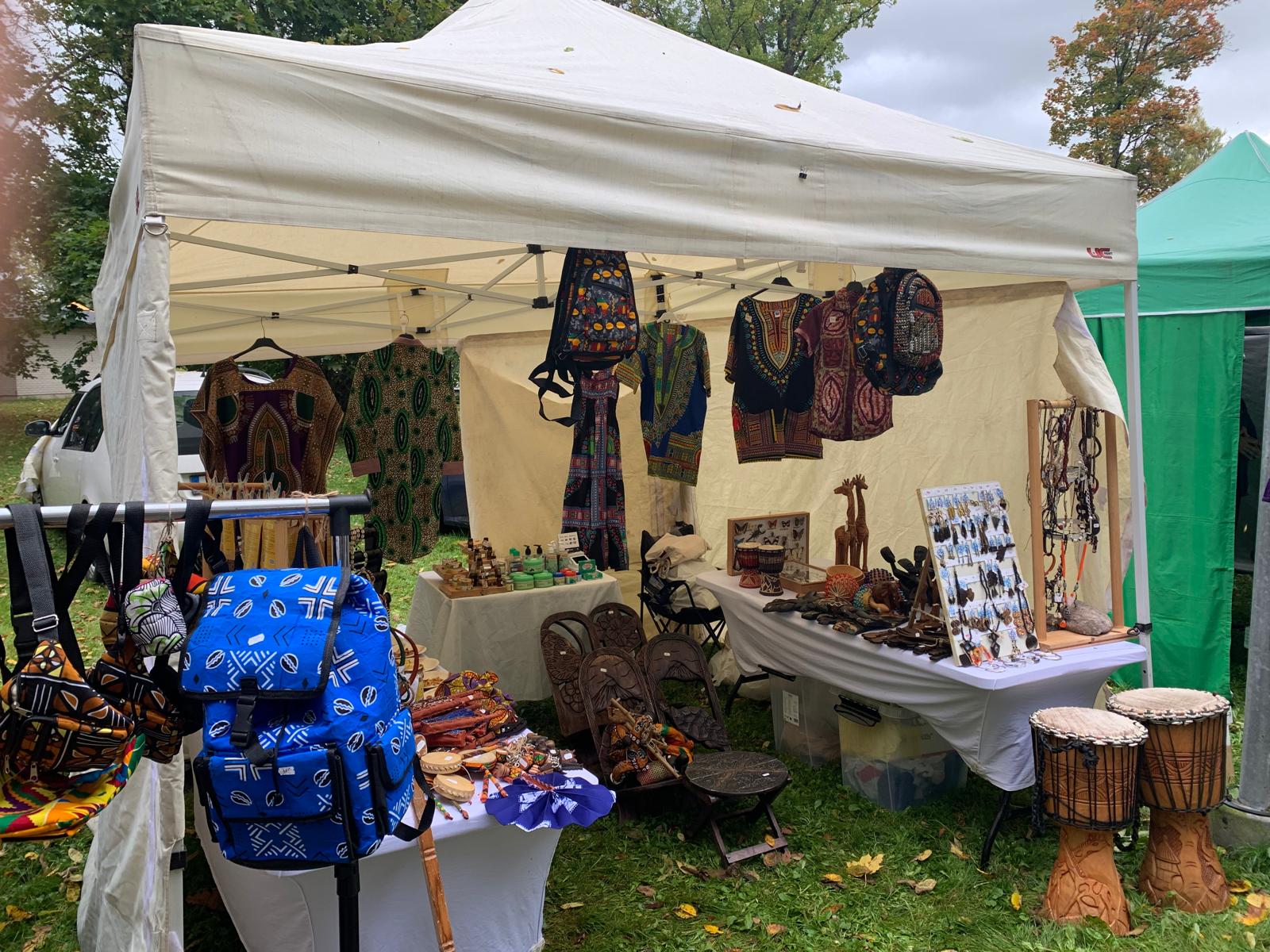 Close-up of TogoSunny's dashikis, bags, jewellery and djembes on display