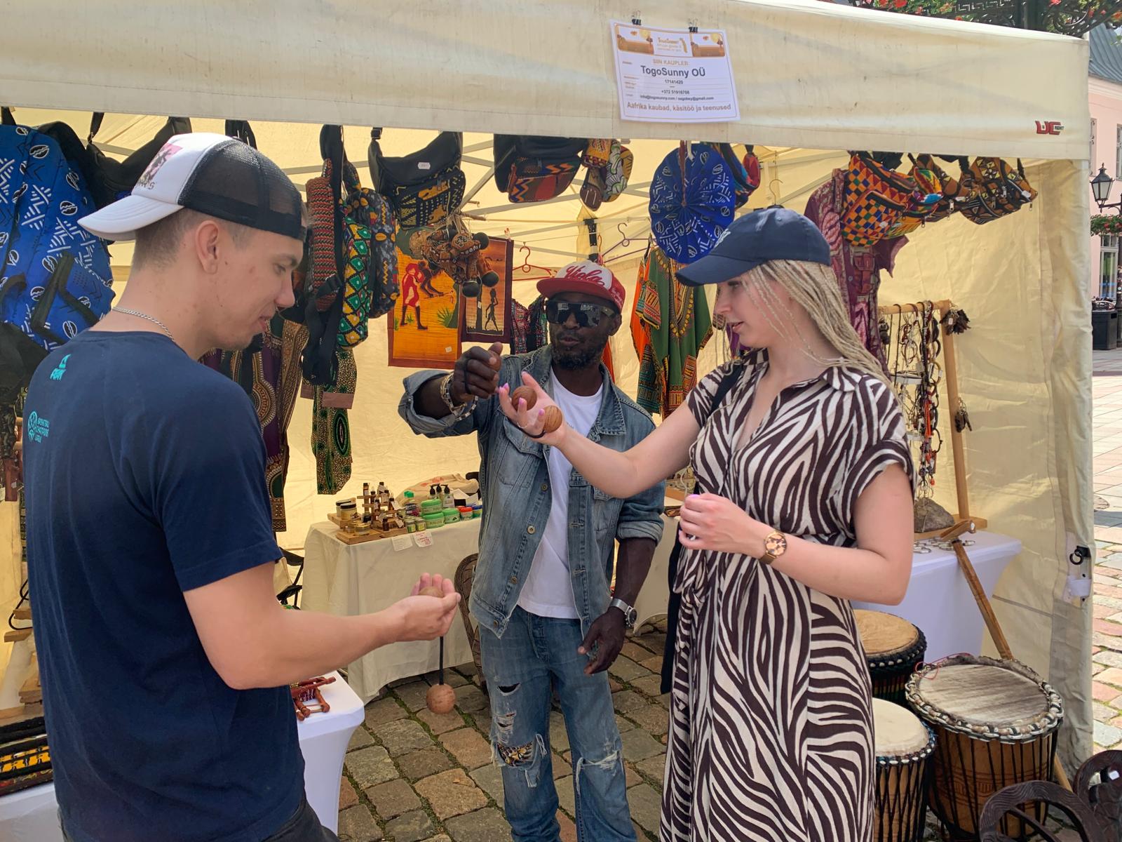 Showing a wooden maraca to visitors
