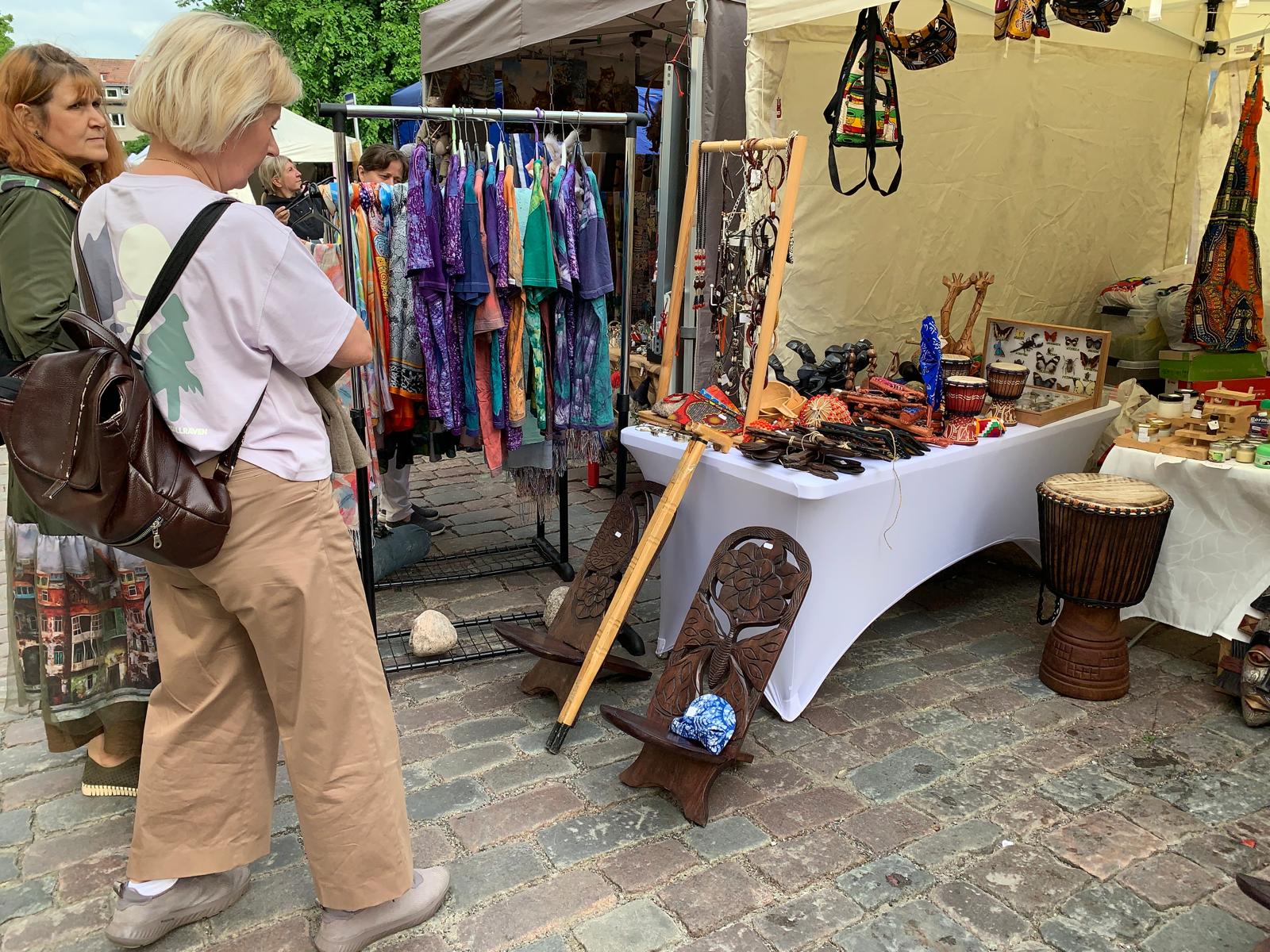 Visitors browsing jewellery and carvings on the TogoSunny table