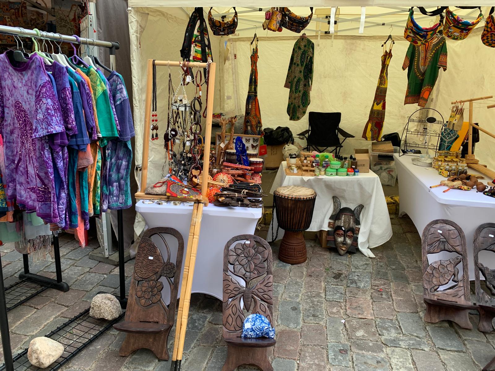 Close view of the TogoSunny tent with masks, djembe drum and dresses